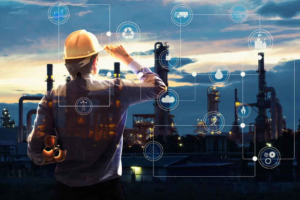 An engineer in a hard hat looks out over an industrial refinery at dusk, with a digital overlay showing interconnected icons for logistics, recycling, energy, and smart technology.