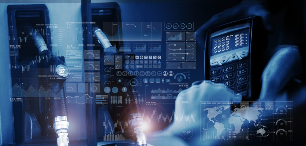 A blue-toned digital montage showing fuel pump nozzles and a hand using a point-of-sale terminal, overlaid with complex data visualisations, stock market charts, and a world map.
